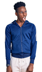 Young african american man wearing sportswear angry and mad screaming frustrated and furious, shouting with anger. rage and aggressive concept.