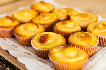 Delicious cupcakes with cream arranged on white napkin in plate