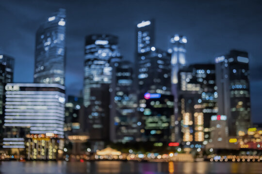 Blurred image bokeh of skyscraper around Marina Bay in Singapore at night