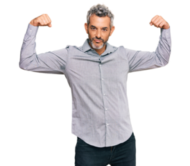 Middle age grey-haired man wearing casual clothes showing arms muscles smiling proud. fitness concept.