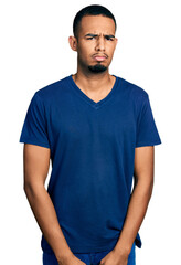 Obraz premium Young african american man wearing casual t shirt skeptic and nervous, frowning upset because of problem. negative person.