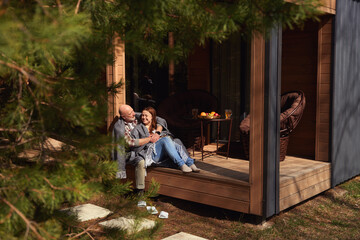 Couple in love resting on cottage veranda