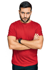 Fototapeta premium Young hispanic man wearing casual clothes skeptic and nervous, disapproving expression on face with crossed arms. negative person.