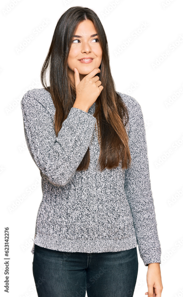 Poster Young brunette woman wearing casual winter sweater with hand on chin thinking about question, pensive expression. smiling with thoughtful face. doubt concept.