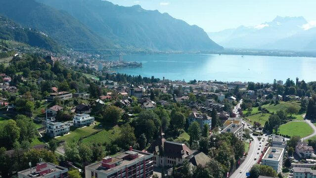 Aerial flight over city of Montreux towards Lake Geneva.Switzerland. The mountains of the Alps in the background.