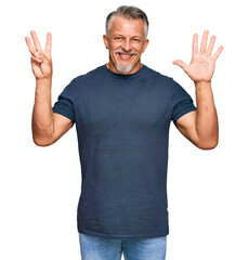 Middle age grey-haired man wearing casual clothes showing and pointing up with fingers number eight while smiling confident and happy.