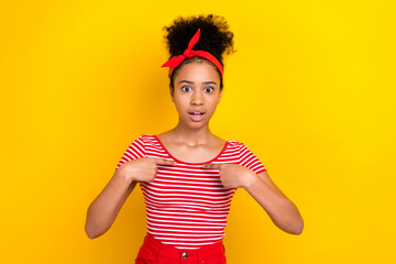 Photo of impressed funky girl dressed red striped t-shirt pointing fingers herself isolated yellow color background