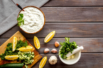 Greek dip sauce ingredients - sour cream with herbs cucumber