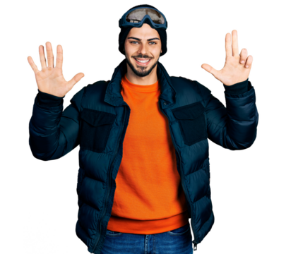 Young hispanic man with beard wearing snow wear and sky glasses showing and pointing up with fingers number eight while smiling confident and happy.