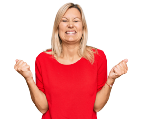 Middle age caucasian woman wearing casual clothes very happy and excited doing winner gesture with arms raised, smiling and screaming for success. celebration concept.