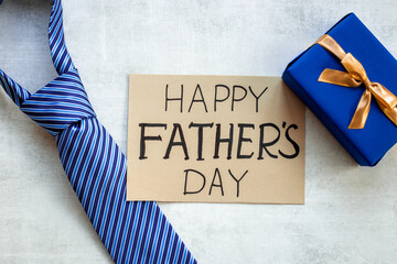 Postcard concept flatlay for Happy Fathers day with blue tie