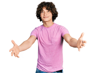 Caucasian teenager wearing casual clothes looking at the camera smiling with open arms for hug. cheerful expression embracing happiness.