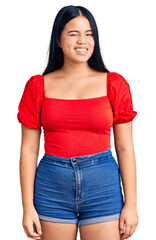 Obraz premium Young beautiful asian girl wearing casual clothes winking looking at the camera with sexy expression, cheerful and happy face.