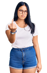 Young beautiful asian girl wearing casual clothes and glasses showing middle finger, impolite and rude fuck off expression