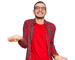 Hispanic young man wearing casual clothes smiling cheerful with open arms as friendly welcome, positive and confident greetings