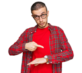 Hispanic young man wearing casual clothes in hurry pointing to watch time, impatience, upset and angry for deadline delay