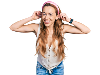 Young caucasian woman wearing casual style with sleeveless shirt smiling pulling ears with fingers, funny gesture. audition problem