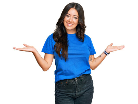 Beautiful brunette young woman wearing casual clothes smiling showing both hands open palms, presenting and advertising comparison and balance