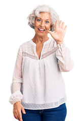 Obraz premium Senior grey-haired woman wearing casual clothes showing and pointing up with fingers number five while smiling confident and happy.