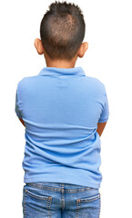 Little boy hispanic kid wearing casual clothes standing backwards looking away with crossed arms © Krakenimages.com