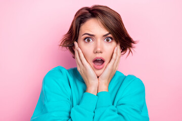 Photo portrait of pretty young girl arms touch face astonished frightened wear trendy blue outfit isolated on pink color background