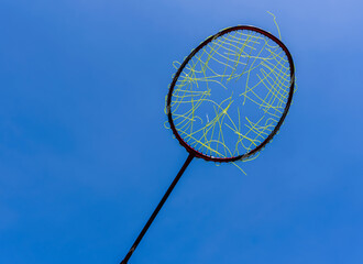 Broken Badminton racket strings on blue background, Badminton sports