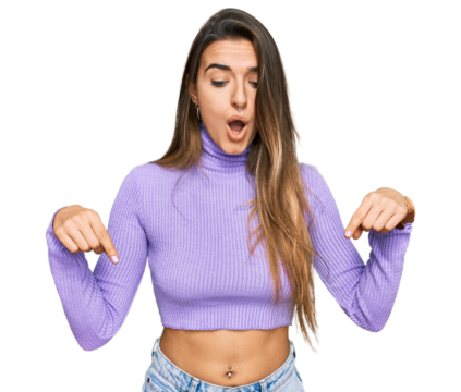 Young hispanic woman wearing casual clothes pointing down with fingers showing advertisement, surprised face and open mouth