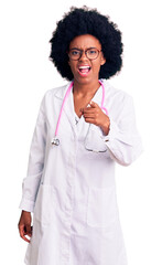 Young african american woman wearing doctor coat and stethoscope pointing displeased and frustrated to the camera, angry and furious with you