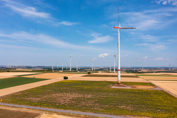 Fototapeta premium Bird's-eye view of a wind farm and a photovoltaic free-field system in between in Rhineland-Palatinate near Wörrstadt/Germany in the middle of grain fields
