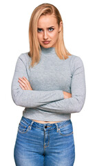 Beautiful caucasian woman wearing casual clothes skeptic and nervous, disapproving expression on face with crossed arms. negative person.