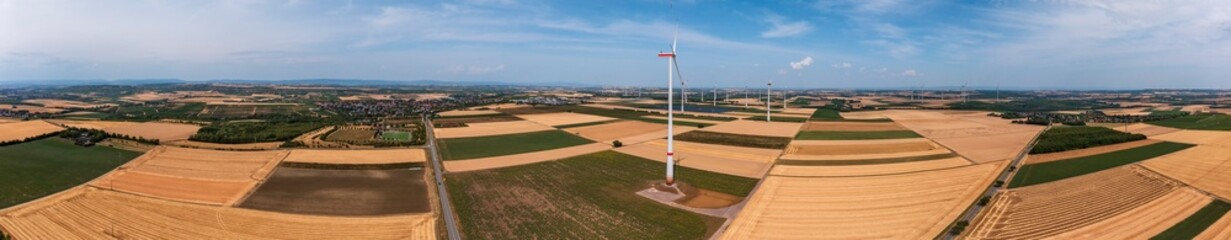 Bird's-eye view of a wind farm and a photovoltaic free-field system in between in Rhineland-Palatinate near Wörrstadt/Germany in the middle of grain fields