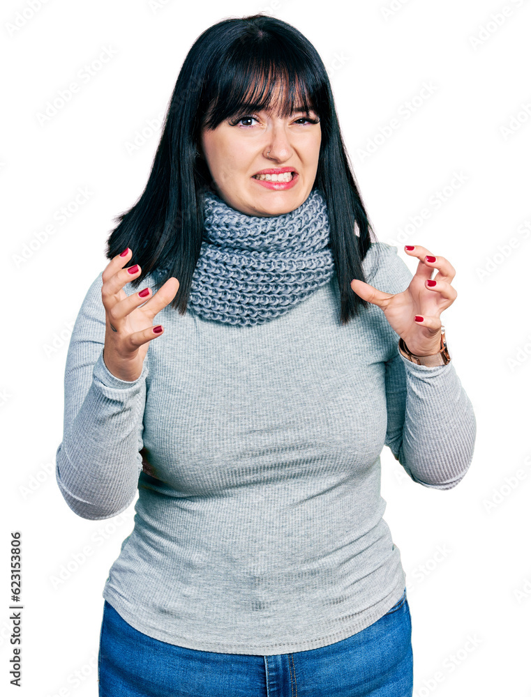 Sticker young hispanic plus size woman wearing winter scarf shouting frustrated with rage, hands trying to s