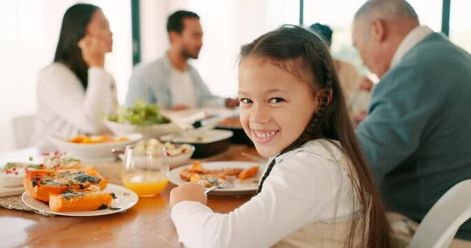 Thanksgiving, smile and a girl with her family for a celebration together while eating food or bonding. Love, lunch or brunch with the portrait of a female kid at the dining room table in a home