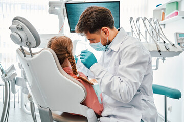 A dentist works in a dental office. Children's dentistry.