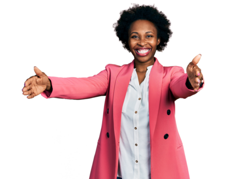 African american woman with afro hair wearing business jacket looking at the camera smiling with open arms for hug. cheerful expression embracing happiness.