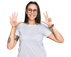 Young hispanic woman wearing casual white t shirt showing and pointing up with fingers number eight while smiling confident and happy.