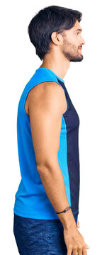 Handsome hispanic man wearing sportswear looking to side, relax profile pose with natural face with confident smile.