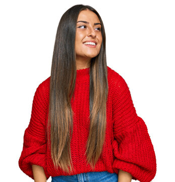 Beautiful hispanic woman wearing casual clothes looking away to side with smile on face, natural expression. laughing confident.