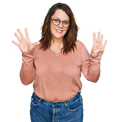 Young plus size woman wearing casual clothes and glasses showing and pointing up with fingers number nine while smiling confident and happy.