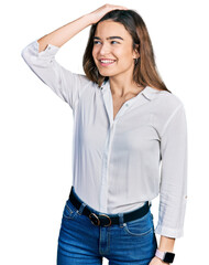 Young caucasian girl wearing casual white shirt smiling confident touching hair with hand up gesture, posing attractive and fashionable