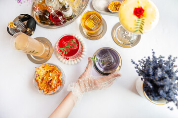 Colorful summer cocktails in glasses on the white table. 