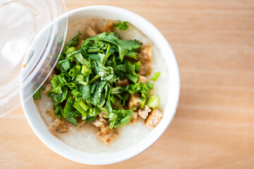 Pork congee or rice porridge with minced pork sprinkled with coriander in white bowl for new morning. Asia breakfast