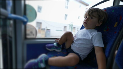Little boy sitting inside bus transportation