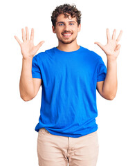 Young handsome man with curly hair wearing casual clothes showing and pointing up with fingers number nine while smiling confident and happy.