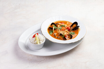 Traditional tom yum soup. On a light background.