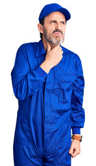 Middle age handsome man wearing mechanic uniform touching painful neck, sore throat for flu, clod and infection