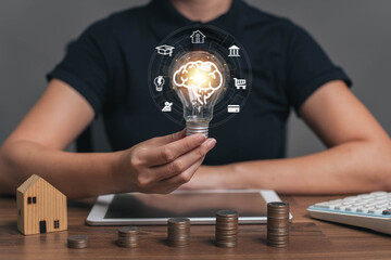 Light bulb in hand. One concept, money planning. Savings and financial division. Investment in education. Savings to pay home taxes. Savings for future business investments