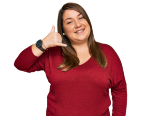 Beautiful brunette plus size woman wearing casual clothes smiling doing phone gesture with hand and fingers like talking on the telephone. communicating concepts.