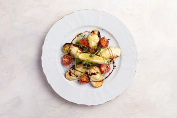 Cooked mussels with cheese in a plate.