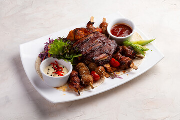 Assorted grilled meats. On a light background.
